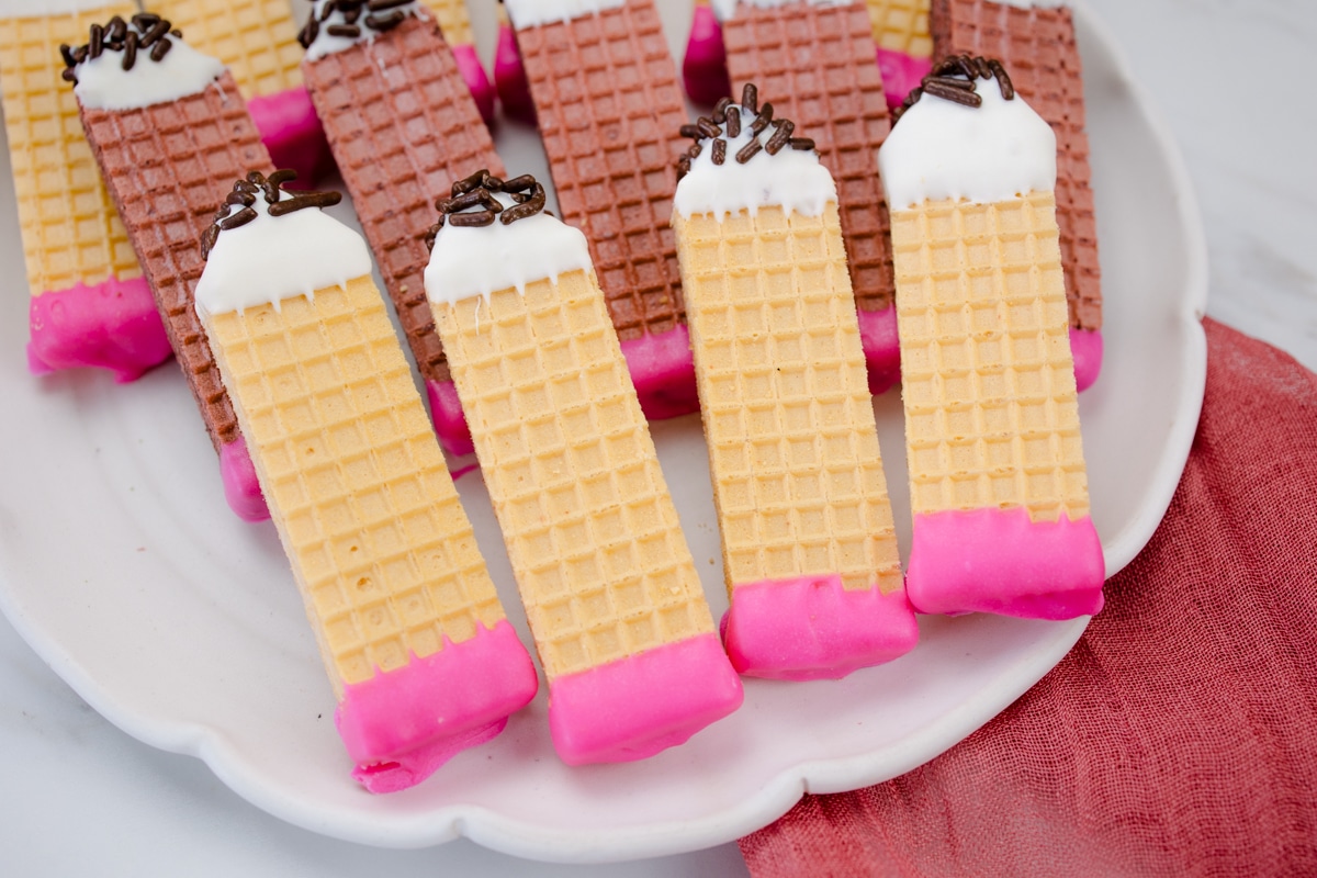 Pencil Wafer Cookies on a white plate.