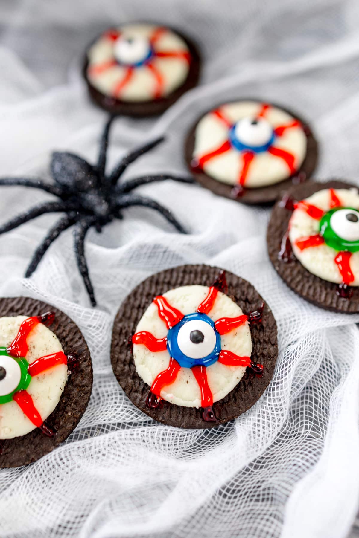 Top view of eyeball cookies next to a plastic spider.