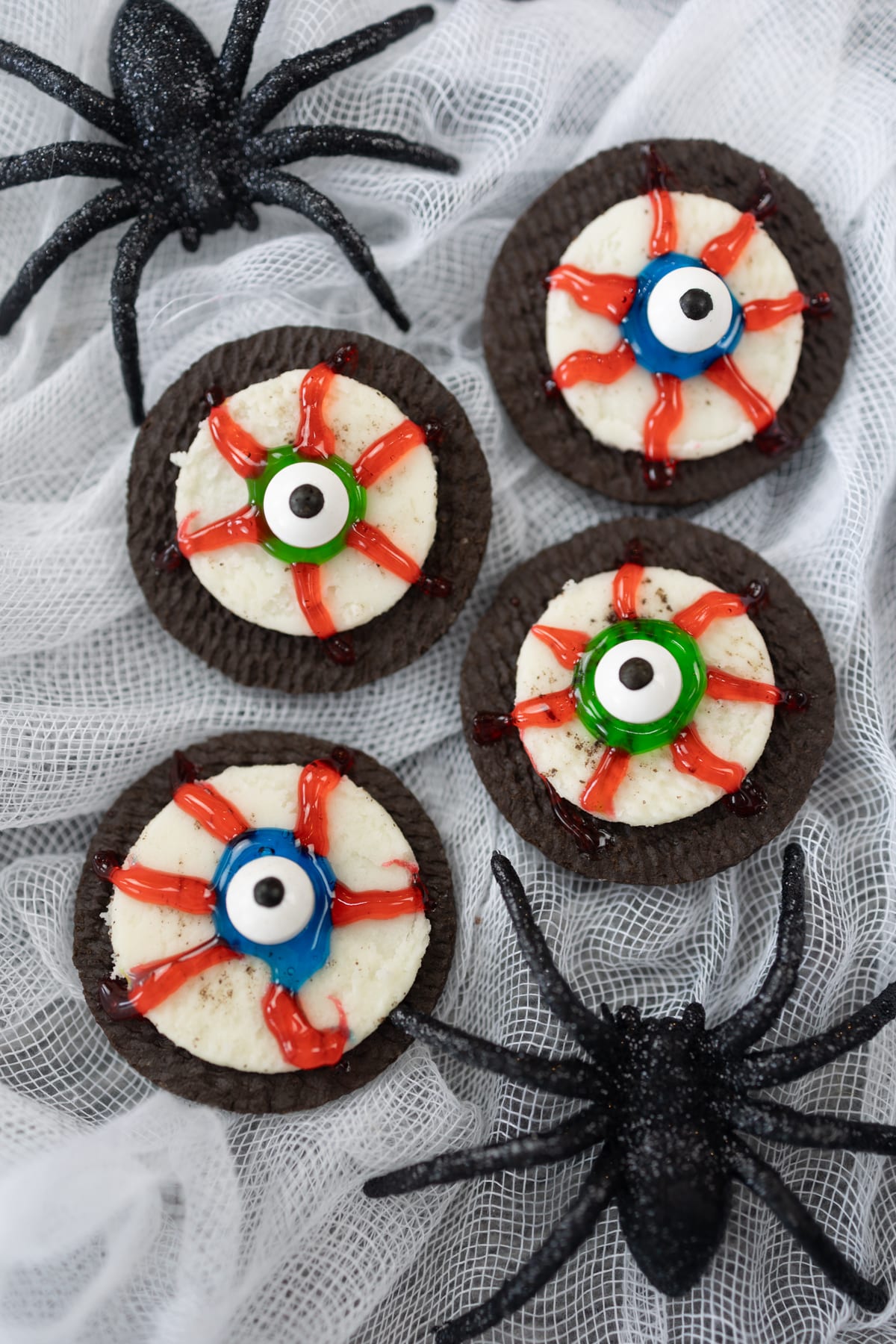 Top view of eyeball cookies next to a plastic spider.