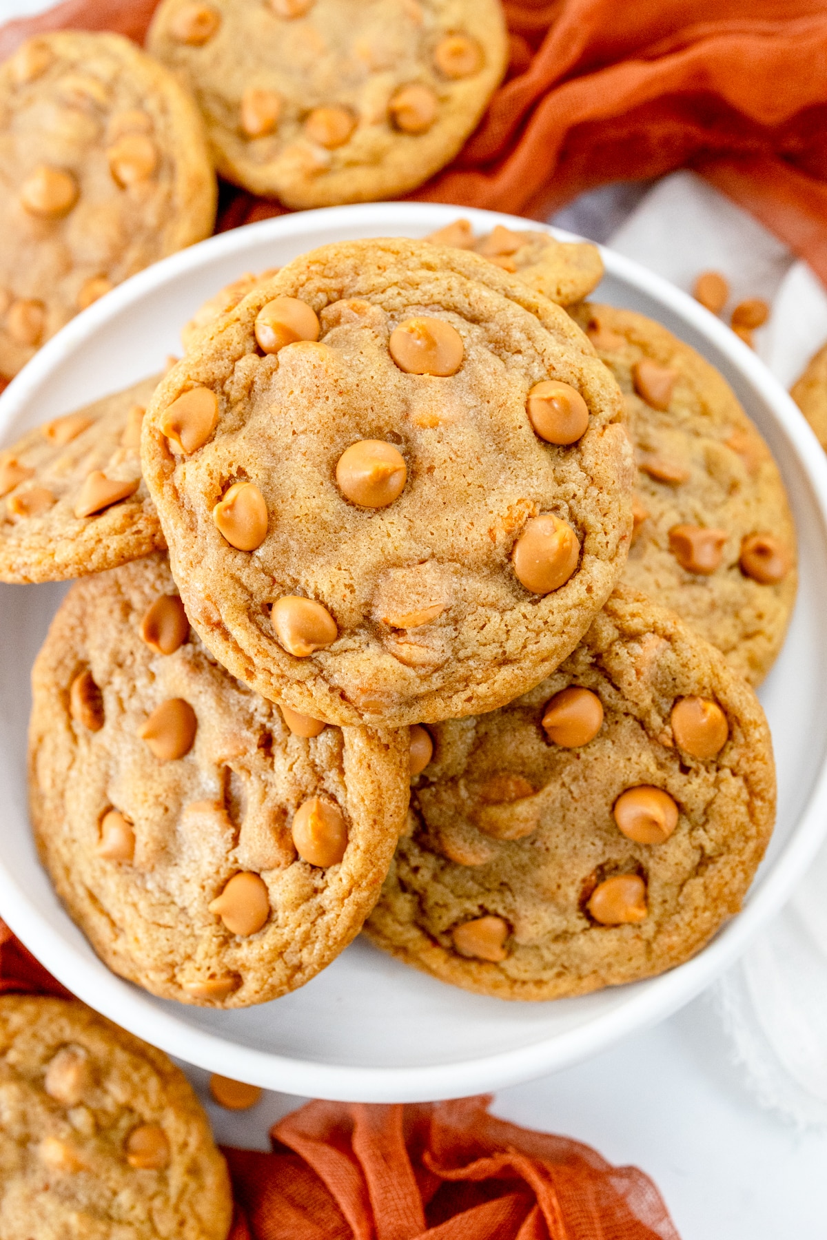 Top view of a plate of Butterscotch Chip Cookies, with other cookies around it.