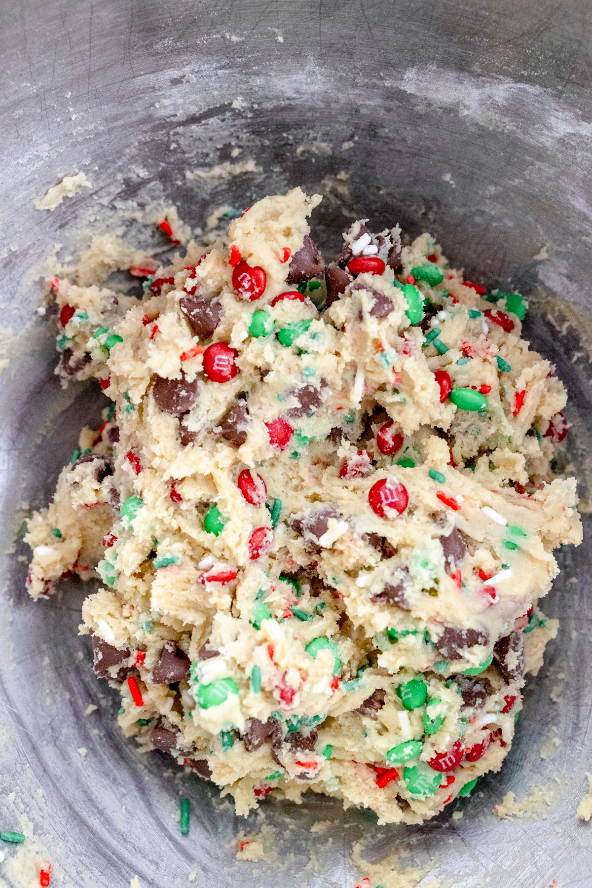 Close up of the bowl of a stand mixer with cookie dough ready to be scooped out.