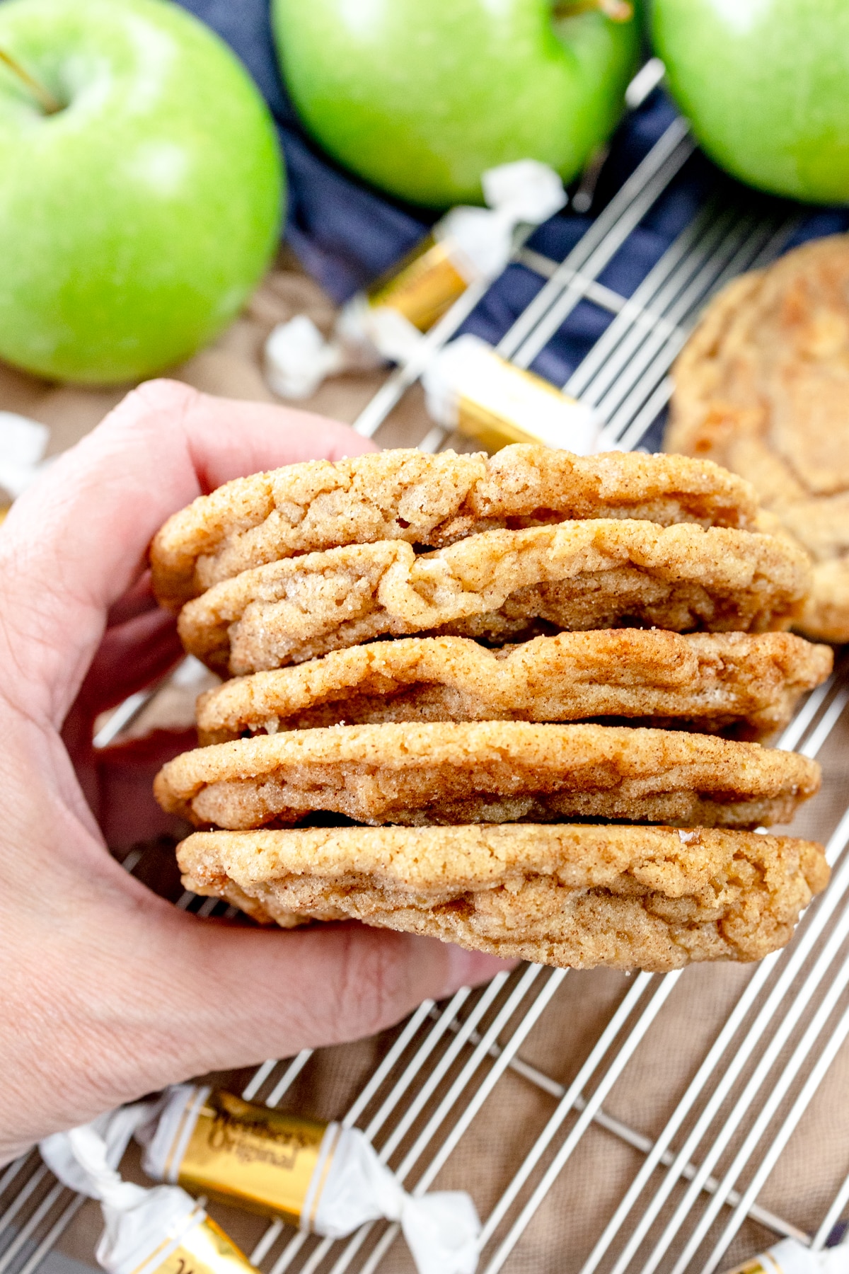 Top view close up of a stack of caramel apple snickerdoodle cookies being held up.