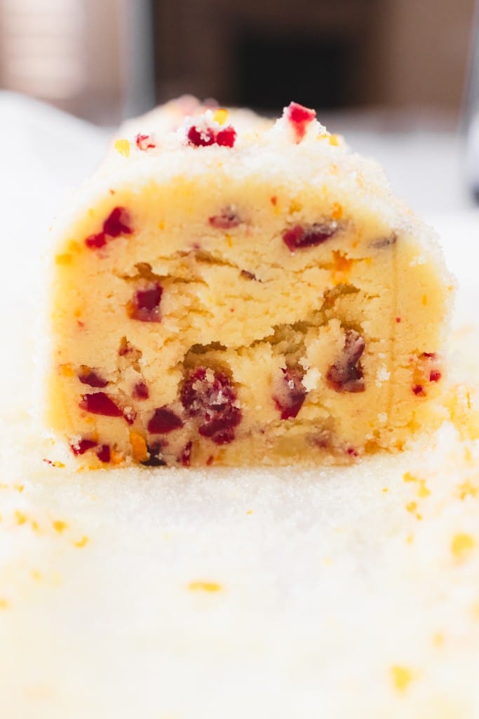 Close up of the roll of cranberry orange shortbread after bring sliced.