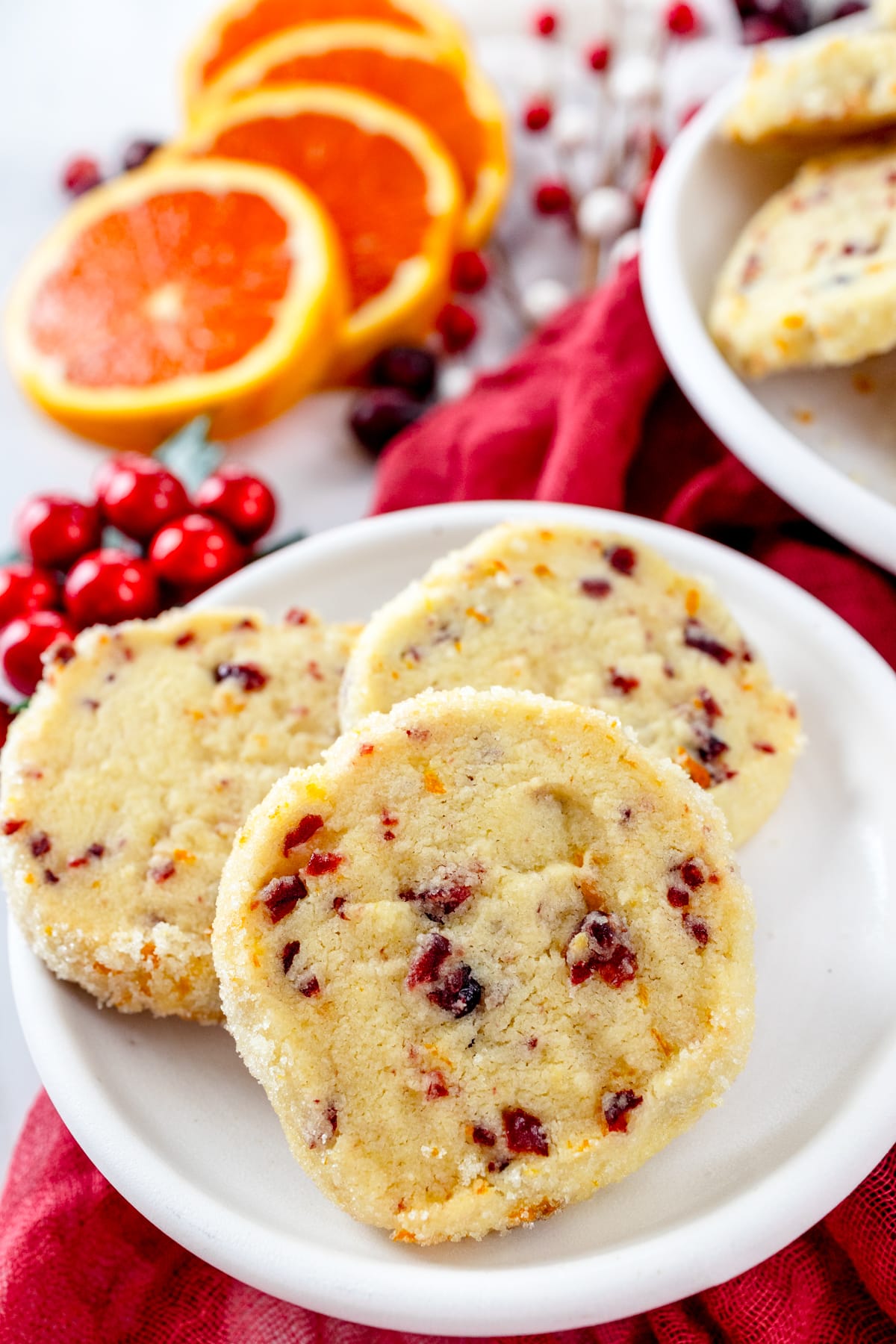 Top view of Cranberry Orange Shortbread Cookies in a stack on a plate.