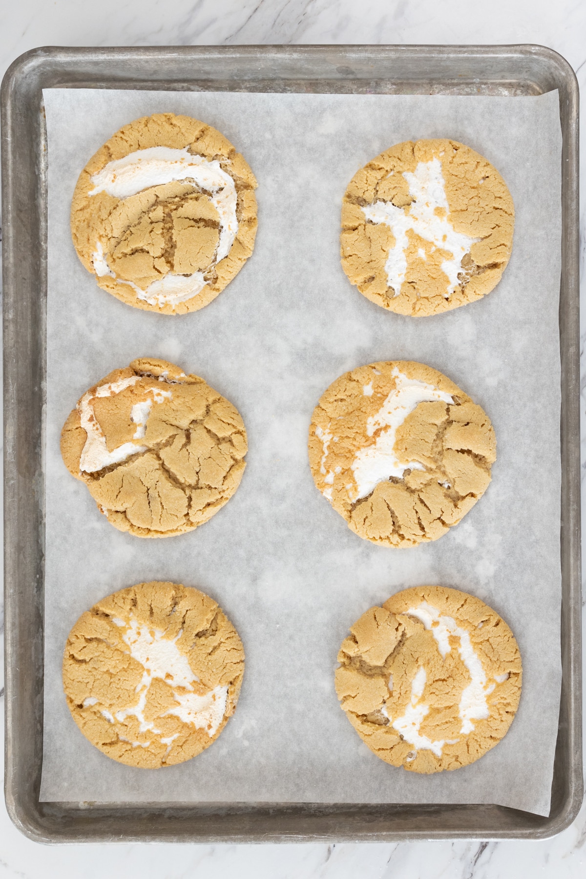 Top view of Fluffernutter Cookies on a baking tray lined with parchment paper.
