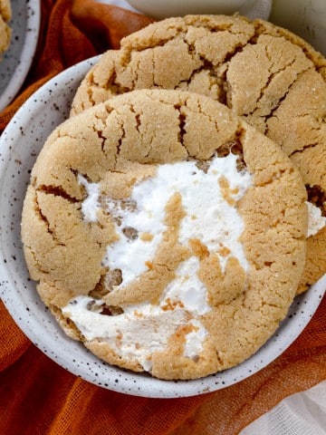 Close up view of Fluffernutter Cookies on a white plate on a decorated table.