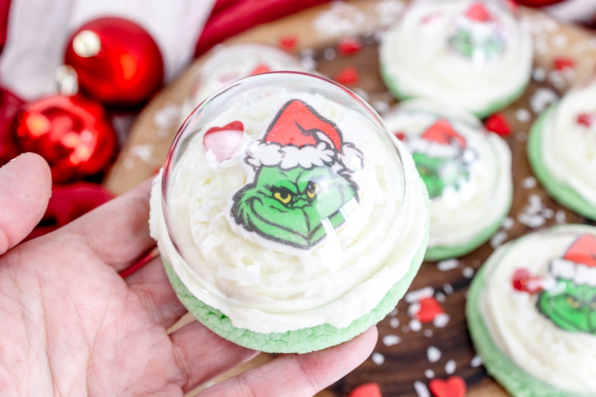 Grinch Snow Globe Cookies.  Green Sugar Cookie with Buttercream Frosting