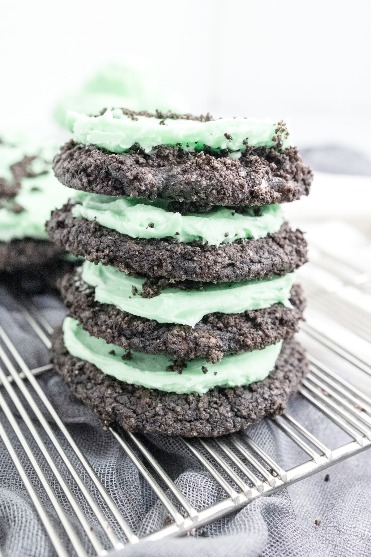 Top view of a stack of Frosted Mint Oreo Cookies on a wire rack.