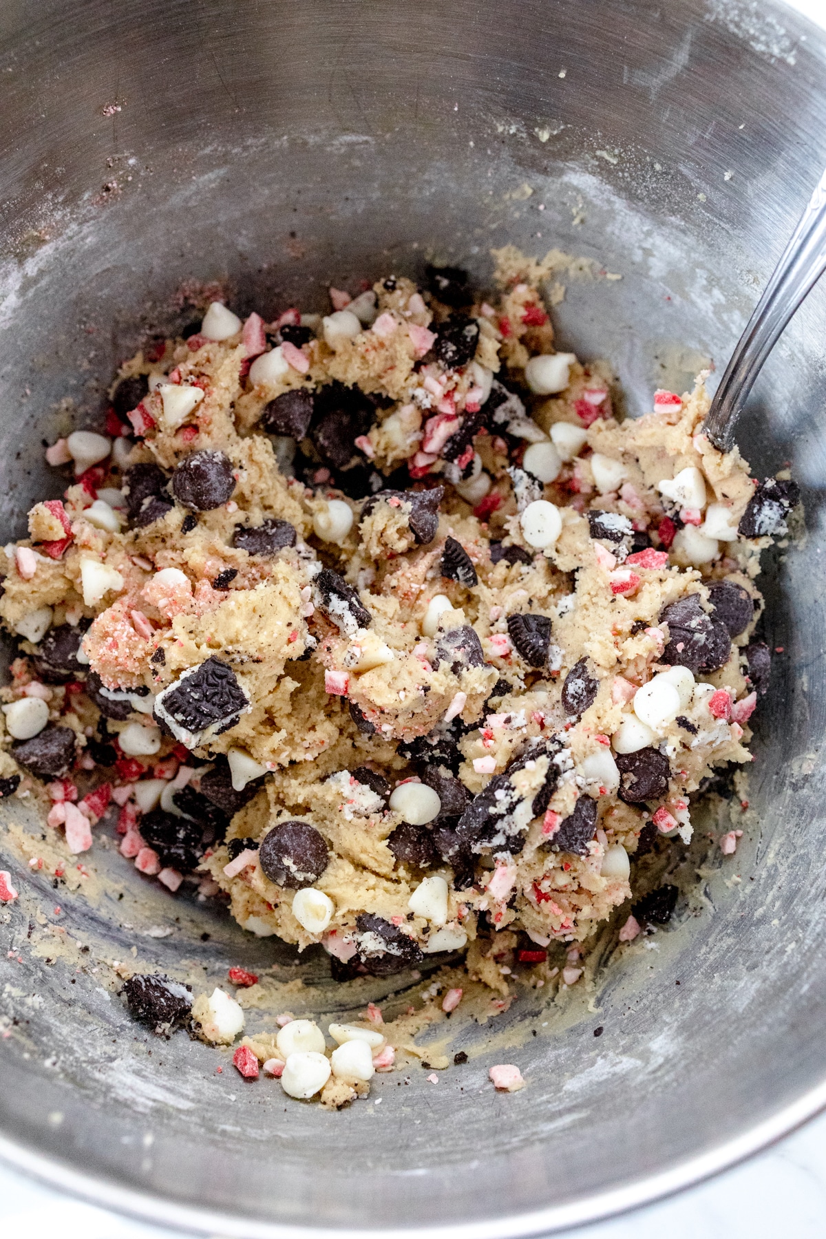 Close up of the bowl of a stand mixer with the fully mixed cookie dough in it.