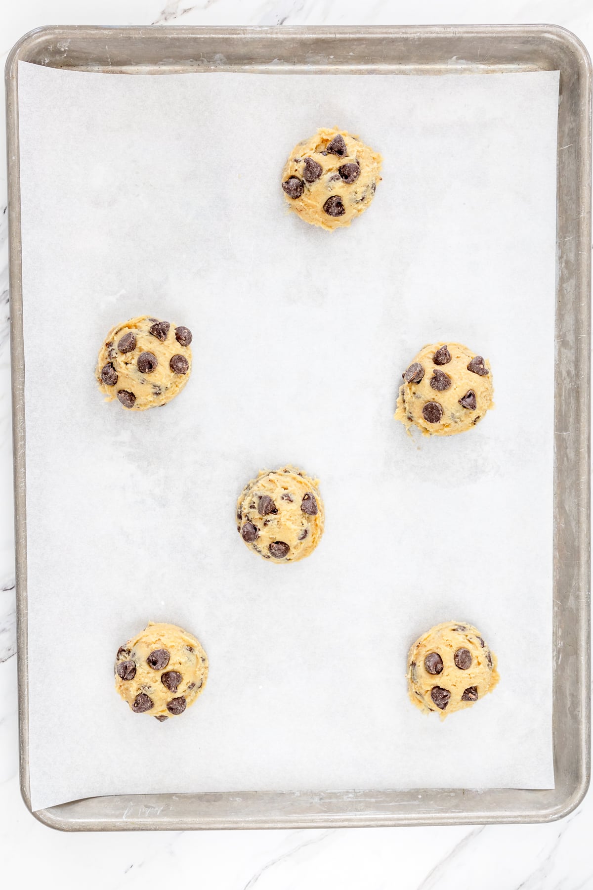 Raw Cookie Dough on Baking Sheet allowing 2 inches between cookies