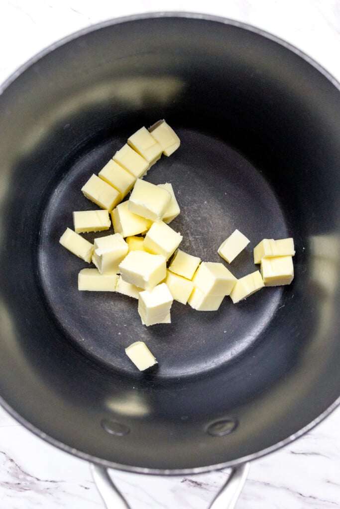 Top view of cubes of butter in a frying pan.