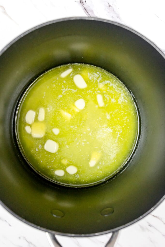 Top view of cubes of butter melting in a frying pan.