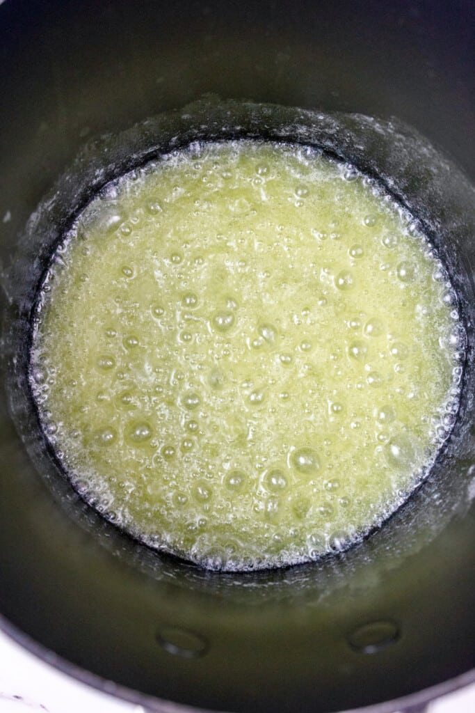 Top view of melted butter in a frying pan.