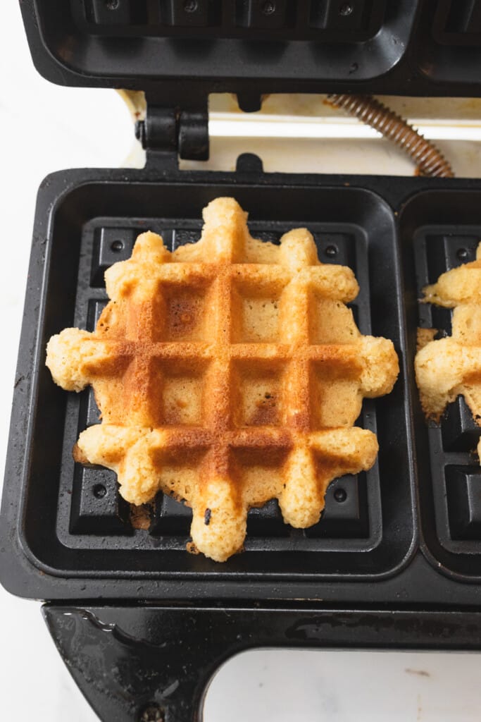 Top view close up of a waffle cookie on a waffle iron.