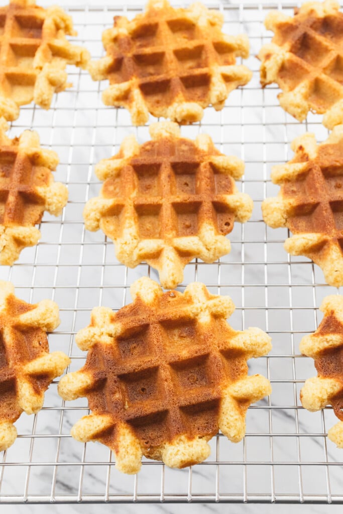 Close up of waffle cookies on a wire rack.