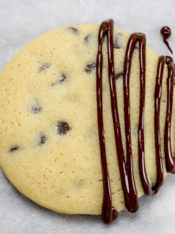 Top view of a chocolate chip cookie with melted chocolate on top.