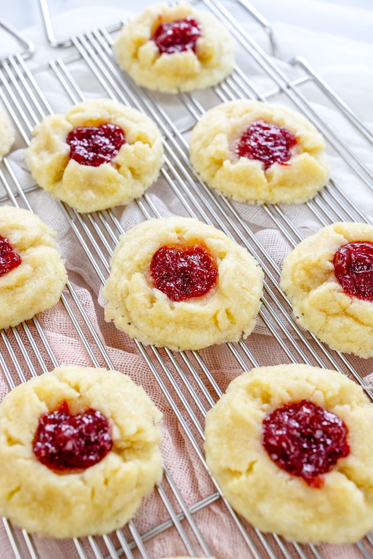 Close up image of Fig Jam Cookies on a wire rack next to a knife with jam on it.