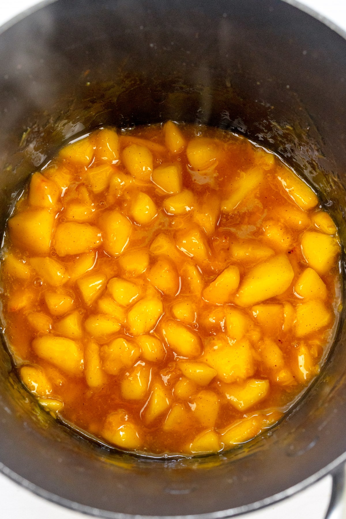 Overhead image of saucepan with peach filling for Peach Pie Bars in it.