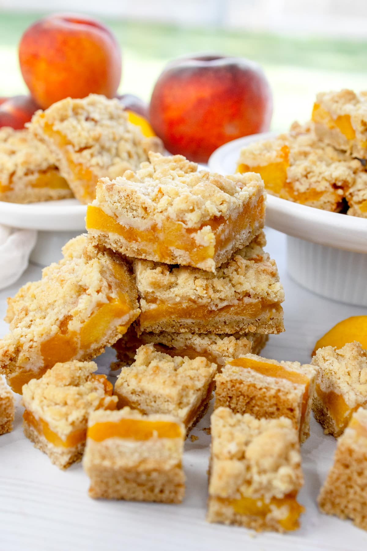 Angled image of Peach Pie Bars in a pile and on plates.